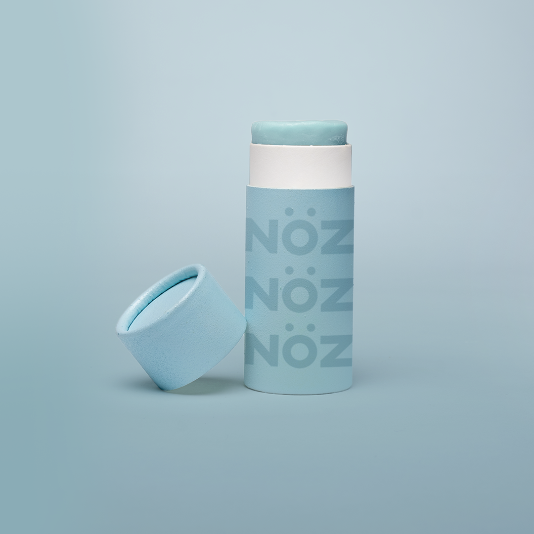 Noz Sunscreen with blue packaging and blue background.